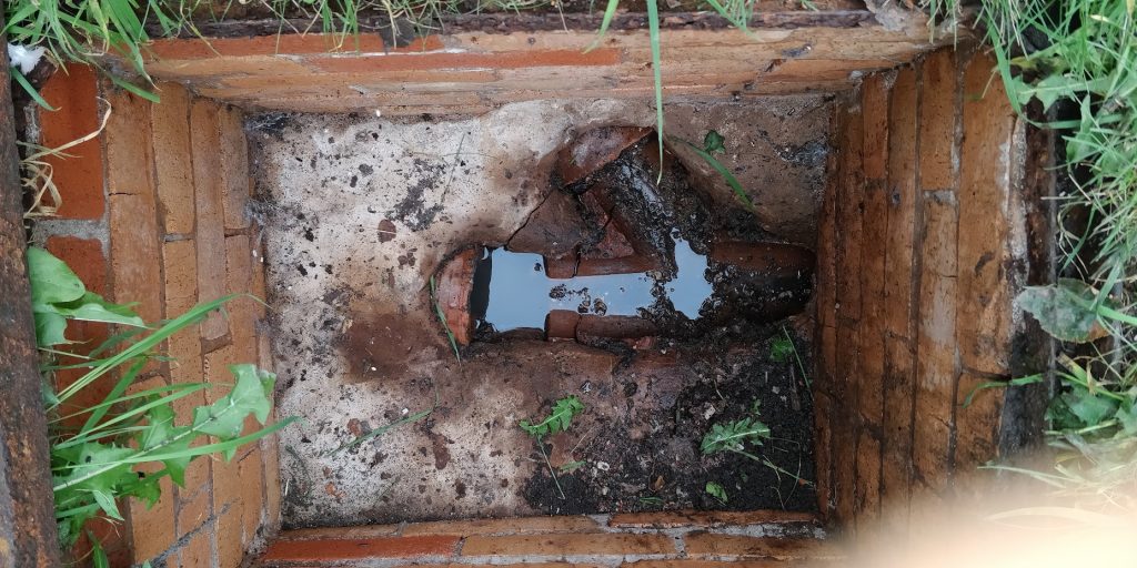 Damaged drain channels exposed in an excavation